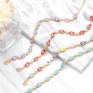 Detail of colorful evil eye bracelets with gold plating and cubic zirconia accents