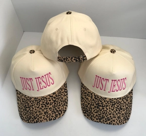 Detail of Just Jesus embroidery and leopard print brim on cotton trucker hat