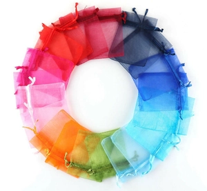 Macro view of colorful drawstring organza gift bags in a vibrant circular arrangement