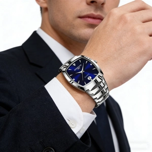 Close-up of men's blue square quartz watch with silver steel band worn with a dark suit