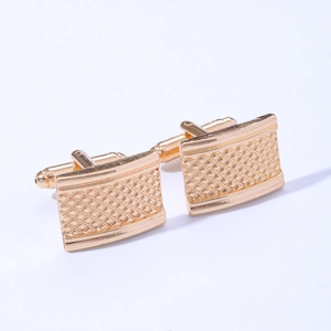 Detailed view of square gold cufflinks featuring an engraved geometric grid pattern