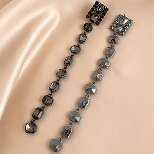 Gothic silver needle tassel earrings with square black rhinestones on champagne satin