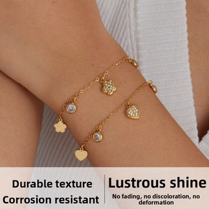 Detail of 18K gold-plated double-layer chain bracelets featuring sparkling floral pendants
