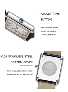 Detail view of the silver rectangular watch case with blue gem crown and stainless back