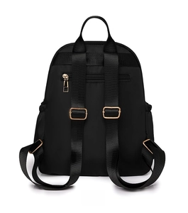 Back view of black nylon backpack featuring gold zippers and secure hidden pocket