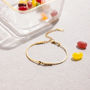 Detail of adjustable 18K gold plated stainless steel bracelet with small white diamonds
