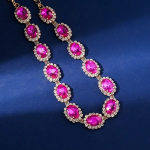 Detail of multi-layered rhinestone necklace featuring bright magenta oval crystals