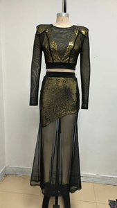 Detail of gold sequins and sheer black mesh fabric on a two-piece party dress