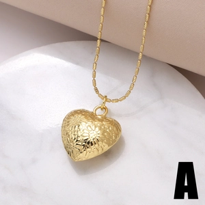 Golden heart pendant necklace with vintage floral relief and elegant bead chain