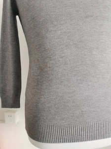 Close-up of gray knit fabric texture and ribbed cuffs on a men's turtleneck sweater