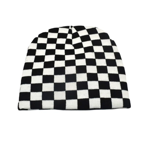 Close-up of black and white checkerboard knit beanie showing detailed stitch texture