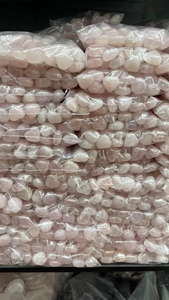 Bulk pack of 15mm rose quartz heart stones in transparent poly bag packaging