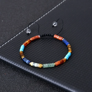 Detail of colorful chakra stones with adjustable black braided cord and tassel beads
