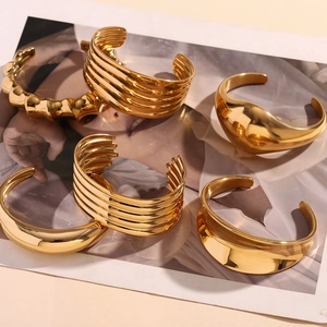 Detail of 18K gold-plated stainless steel bangle set with bamboo and ribbed textures