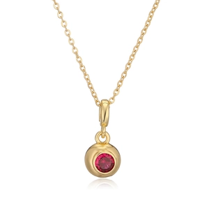 Close-up of gold-plated circular pendant with a red zircon stone on a white background
