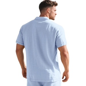 Rear view of a light blue linen polo shirt showing the tailored fit and textured fabric