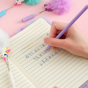 Unicorn stationery set with plush pens and notebook in a warm pink aesthetic scene