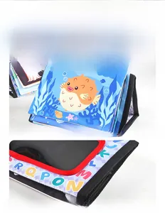 Close-up of durable baby cloth book with ocean animal prints and firm stitching
