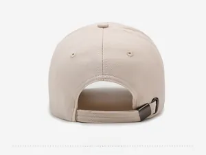 Detail view of the beige baseball cap's back with an adjustable metal buckle strap