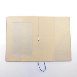 Detail of beige faux leather passport cover with transparent card slots and elastic band