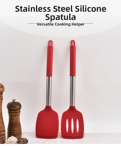 Detail of red silicone and stainless steel spatula set including solid and slotted turners