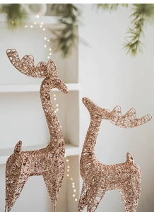 Detail of rose gold iron mesh Christmas reindeer set with glitter and warm lights