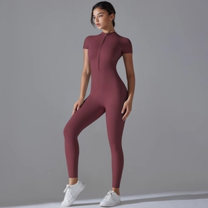 Deep red short sleeve yoga jumpsuit with zipper neckline and form-fitting elastic fabric