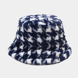 Detailed texture of blue and white houndstooth pattern on plush faux fur bucket hat