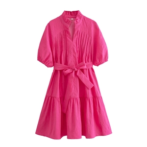 Pink mini dress with textured fabric, ruffle collar, puff sleeves, and a bow waist belt