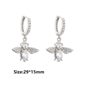 Detailed view of silver bee earrings with white zircon, pearls, and micro-pave crystals