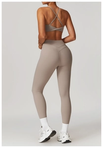 Detail view of khaki high-waisted yoga leggings with V-shaped waistband and lift effect