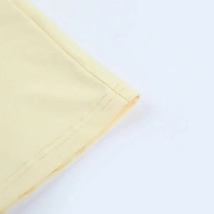 Detail of ruffle sleeve cuff with high-density stitching on yellow bodycon dress