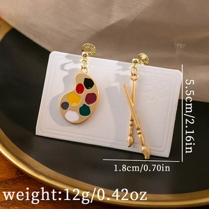 Detailed view of paintbrush and palette asymmetric earrings with size dimensions