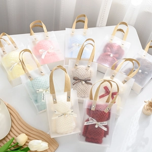 Colorful coral fleece bear towels in transparent gift bags with ribbon bow