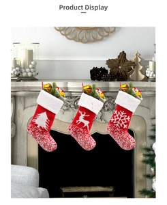 Detailed view of three knitted Christmas stockings with reindeer and tree patterns on a fireplace