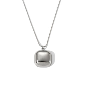 Detail shot of the polished silver square pendant with a sleek snake bone chain texture