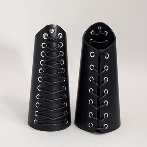 Detail of black rock punk wide leather wristbands with metal eyelets and adjustable laces