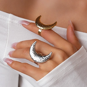 Detailed close-up of large hammered crescent moon open rings in gold and silver finish