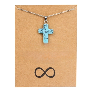 Collier pendentif croix turquoise sur carte d'amitié avec détail de symbole infini