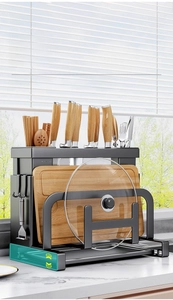 Detail of multi-functional kitchen rack showing knife slots and removable green drain tray