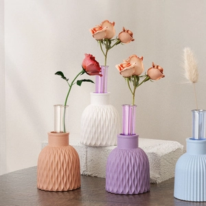 Modern wavy relief vase in pastel colors with glass tube insert on stone base