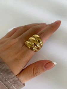 Detail of wide triple-layered 18K gold plated stainless steel ring on female hand