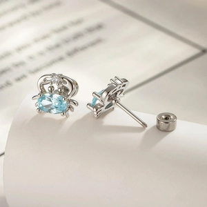 Cute titanium steel sea crab stud earrings with blue gemstone and silver finish
