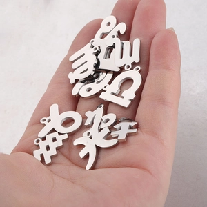 Polished silver stainless steel zodiac charms in hand showing 15mm size and mirror finish