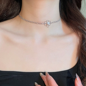 Detail of silver floral pendant necklace with a center pearl on a delicate beaded chain