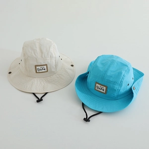 Close-up of quick-dry sun hats with BEAR logo patch and adjustable chin strap