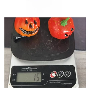 Weight measurement of 15g for the funny Halloween pumpkin hair clip on a digital scale