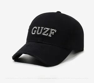 Close-up of black vintage baseball cap featuring GUZF beaded letters and distressed details