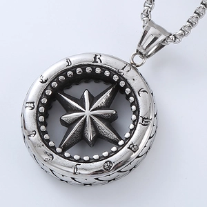 Macro view of silver punk compass pendant with starburst engraving and square link chain
