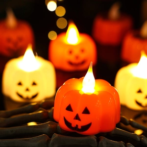 Halloween pumpkin LED candle lights with glowing faces for festive party decorations
